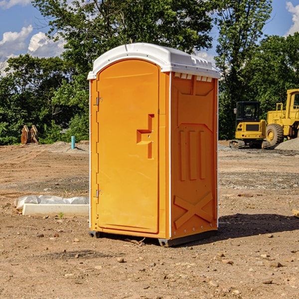 what is the cost difference between standard and deluxe portable restroom rentals in Toone